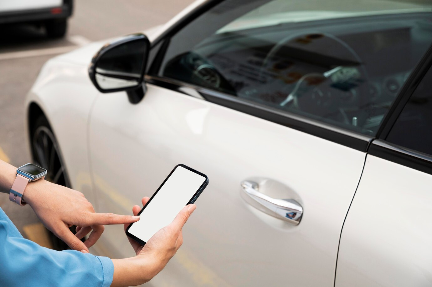 White car and a hand with a phone