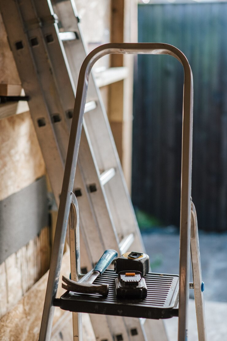 A stepladder with tools on it