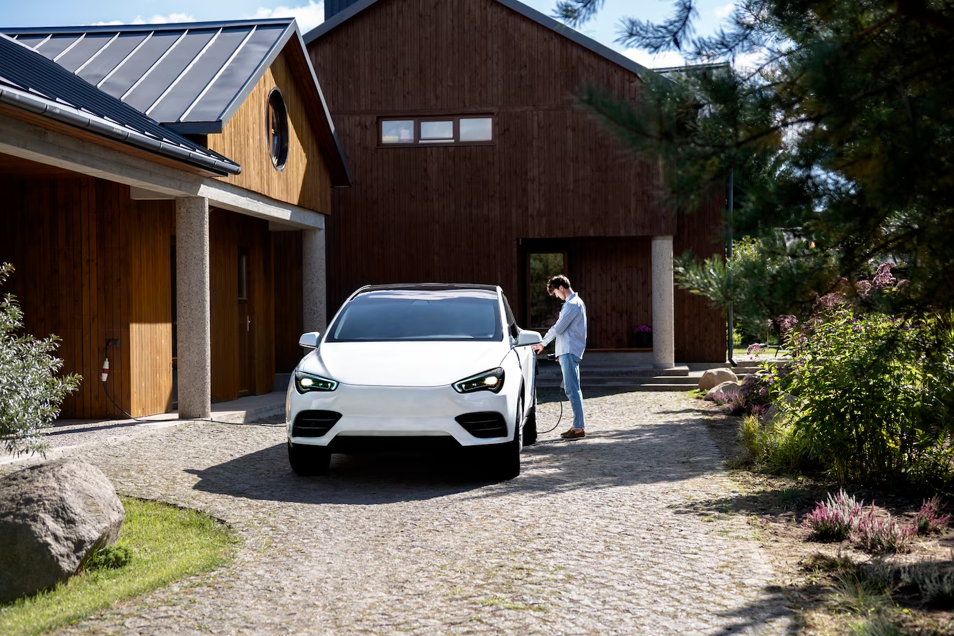 a white car near the wooden garage