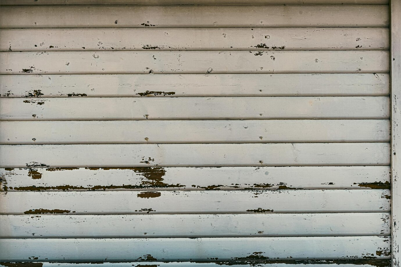 A shabby garage door made of wood