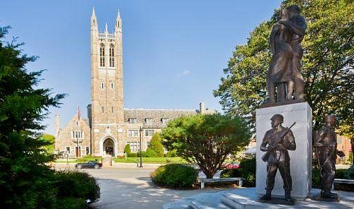 Monument and historic architecture in Norwood, MA, featuring a church and statue surrounded by greenery