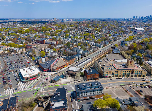 Aerial view of Norwood, MA, showcasing urban infrastructure, buildings, and surrounding residential areas