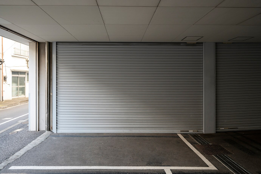 A wooden garage door lined with white bricks