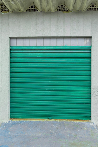 A wooden garage door lined with white bricks