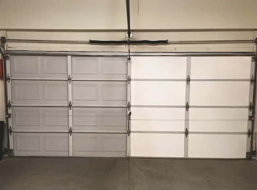 A wooden garage door lined with white bricks
